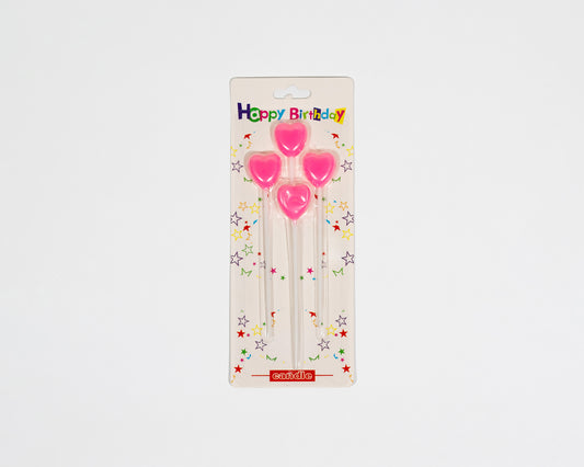 Pink heart candles charm the cake